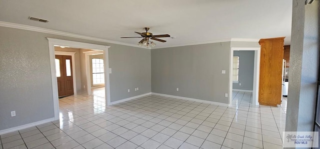 tiled empty room featuring ceiling fan and ornamental molding