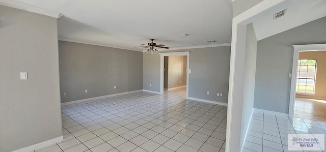 spare room featuring ceiling fan, light tile patterned flooring, and ornamental molding