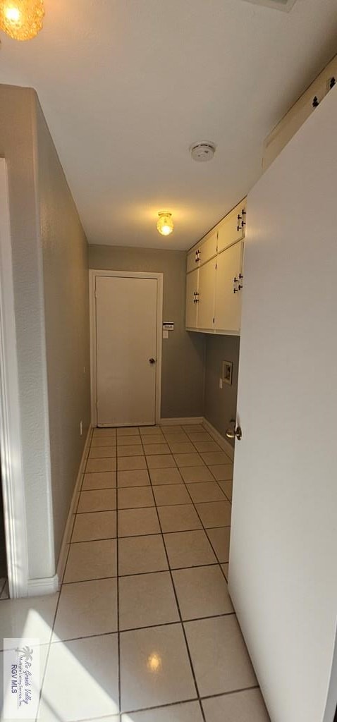 corridor with light tile patterned flooring