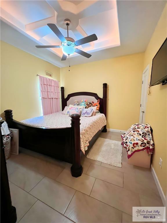 bedroom featuring light tile patterned floors and ceiling fan