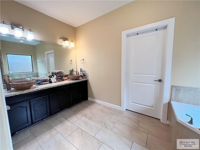 bathroom with vanity and a washtub