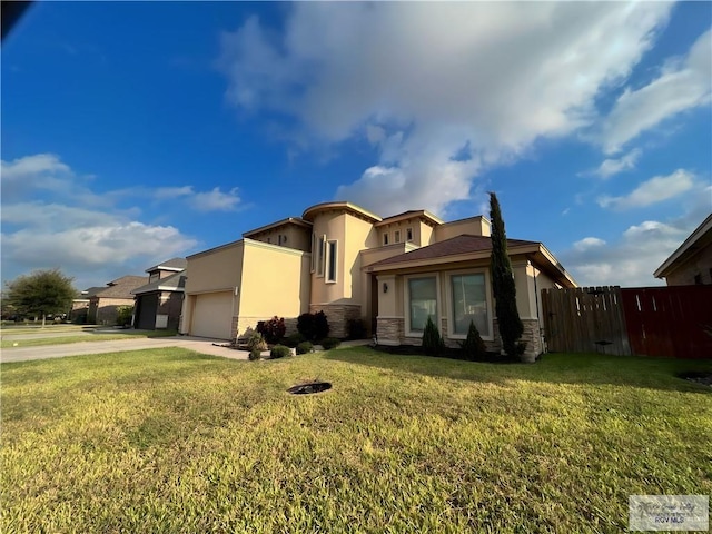 view of front facade with a garage and a front lawn