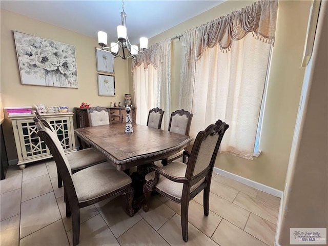 tiled dining area with a chandelier