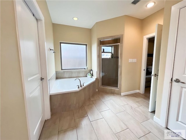 bathroom with shower with separate bathtub