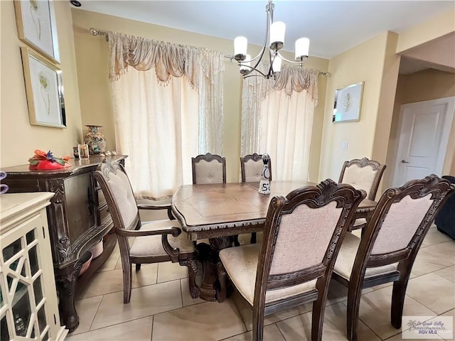 dining area featuring a chandelier and light tile patterned floors