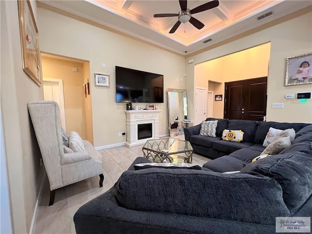 living room featuring beam ceiling, ceiling fan, coffered ceiling, and ornamental molding