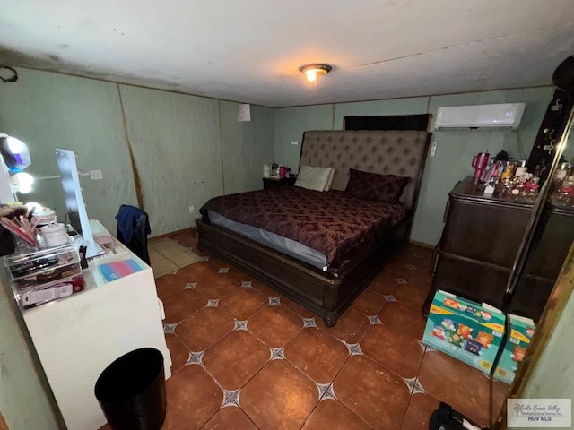 bedroom with tile patterned floors and a wall mounted air conditioner