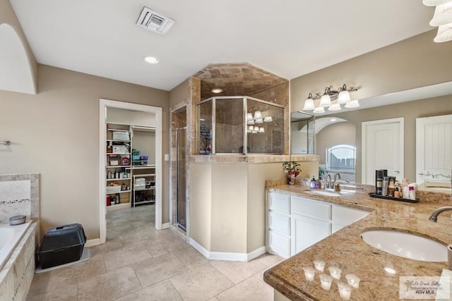 1510 Karis Ct, Harlingen, TX 78550 - full bath with a stall shower, double vanity, a bath, and a spacious closet