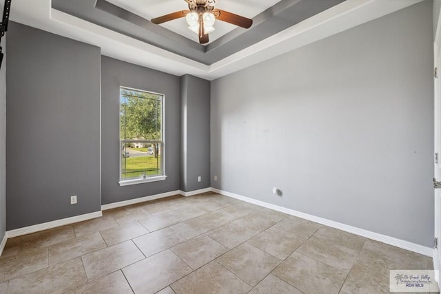 1510 Karis Ct, Harlingen, TX 78550 - empty room featuring a tray ceiling and ceiling fan