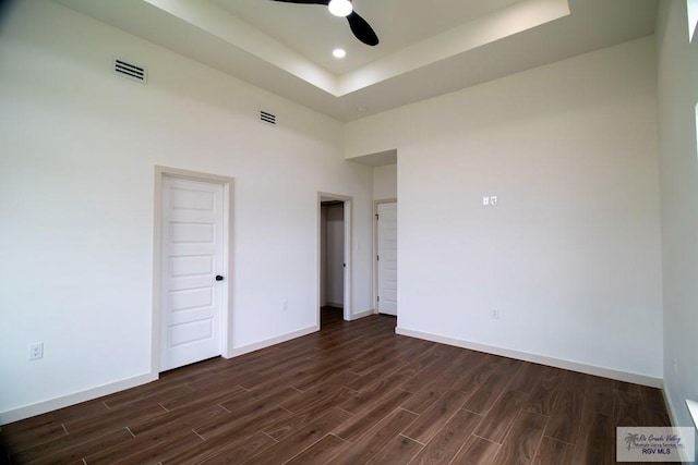 1272 Bridle Way, San Benito, TX 78586 - unfurnished room with dark wood finished floors, a ceiling fan, a raised ceiling, and recessed lighting