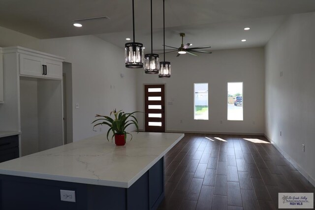 1272 Bridle Way, San Benito, TX 78586 - kitchen featuring a ceiling fan, open floor plan, dark wood-type flooring, white cabinetry, and a center island