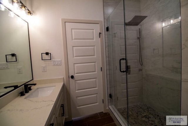 1272 Bridle Way, San Benito, TX 78586 - bathroom with a shower stall, vanity, and wood finished floors