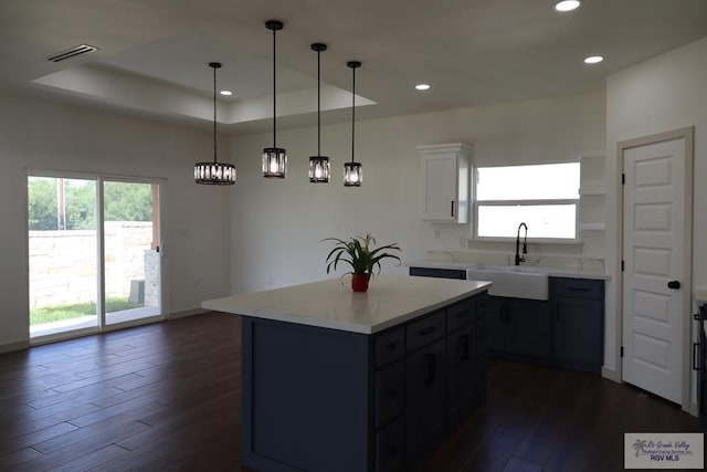 1272 Bridle Way, San Benito, TX 78586 - kitchen featuring dark wood finished floors, recessed lighting, plenty of natural light, and a raised ceiling