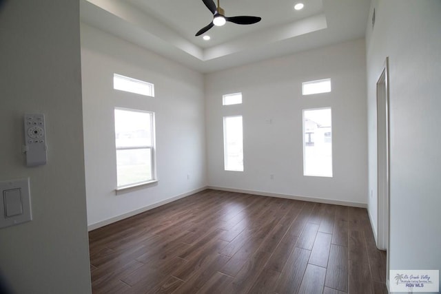 1272 Bridle Way, San Benito, TX 78586 - unfurnished room with ceiling fan, a tray ceiling, dark wood finished floors, recessed lighting, and a towering ceiling