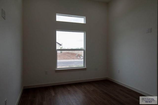 1272 Bridle Way, San Benito, TX 78586 - empty room featuring dark wood-type flooring and baseboards