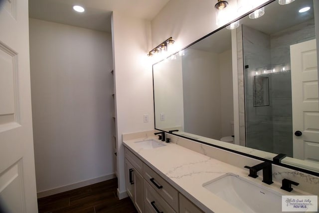 1272 Bridle Way, San Benito, TX 78586 - bathroom with double vanity, wood finished floors, recessed lighting, and a walk in shower