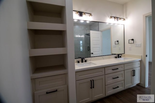 1272 Bridle Way, San Benito, TX 78586 - full bathroom with double vanity, a shower stall, and wood finished floors