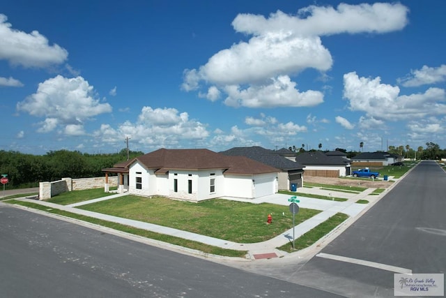 1272 Bridle Way, San Benito, TX 78586 - view of front of property featuring driveway, an attached garage, a front yard, and stucco siding