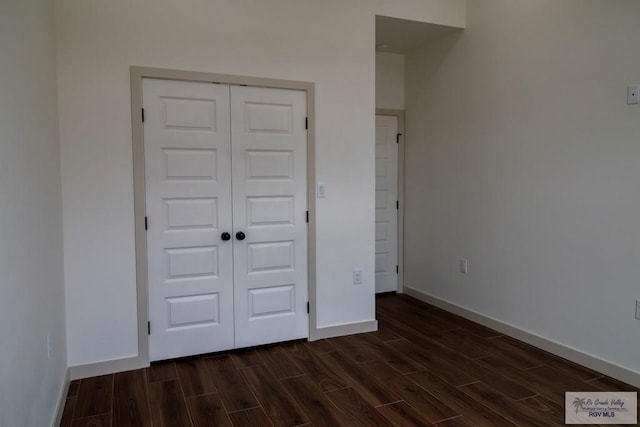 1272 Bridle Way, San Benito, TX 78586 - unfurnished bedroom featuring dark wood finished floors and a closet