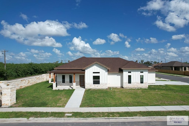 1272 Bridle Way, San Benito, TX 78586 - modern farmhouse featuring board and batten siding, a front yard, a porch, and stone siding