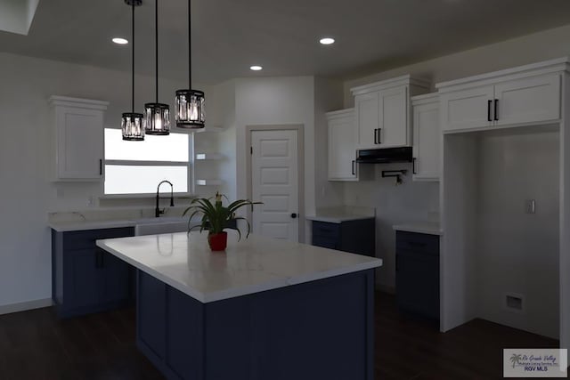 1272 Bridle Way, San Benito, TX 78586 - kitchen featuring under cabinet range hood, dark wood-style floors, white cabinets, pendant lighting, and recessed lighting
