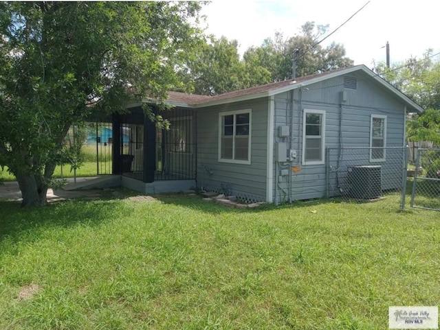 rear view of property featuring a yard