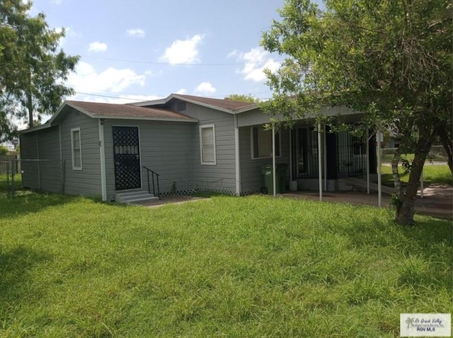 rear view of house with a lawn