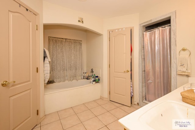 bathroom with vanity, tile patterned flooring, and a bathtub