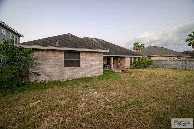 back of house featuring a lawn