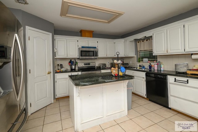 kitchen featuring white cabinets, decorative backsplash, a center island, and stainless steel appliances