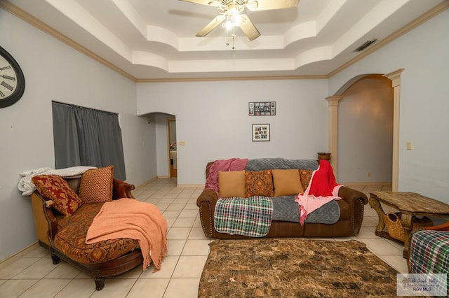 living room with light tile patterned flooring, ornate columns, and crown molding