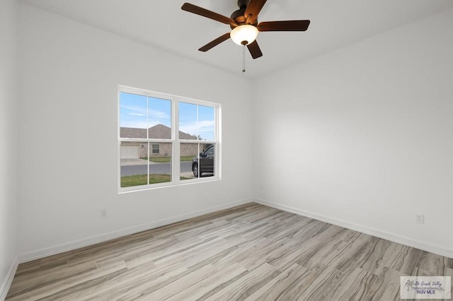 spare room featuring ceiling fan and light wood-type flooring