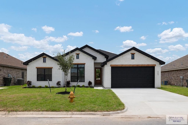 view of front facade featuring a front yard, a garage, and central air condition unit