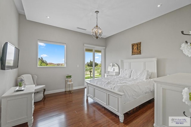 bedroom with access to exterior, dark wood-type flooring, and an inviting chandelier