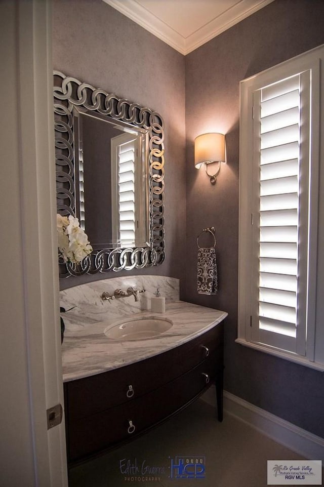 bathroom with crown molding and vanity