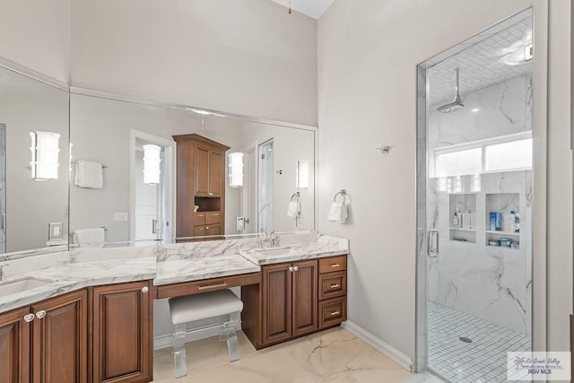 bathroom with vanity and a shower with shower door