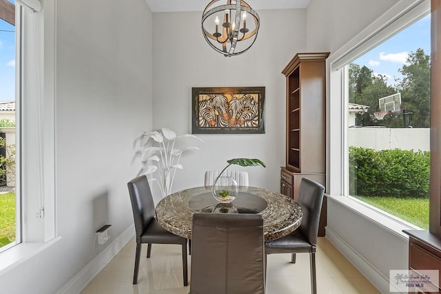 tiled dining room featuring a chandelier and plenty of natural light