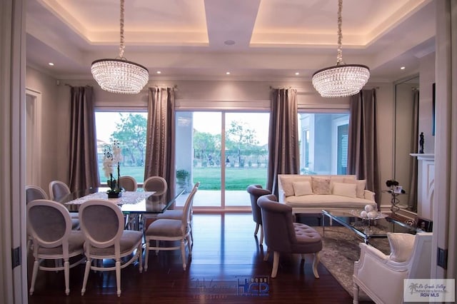 interior space with a raised ceiling, a wealth of natural light, and a notable chandelier