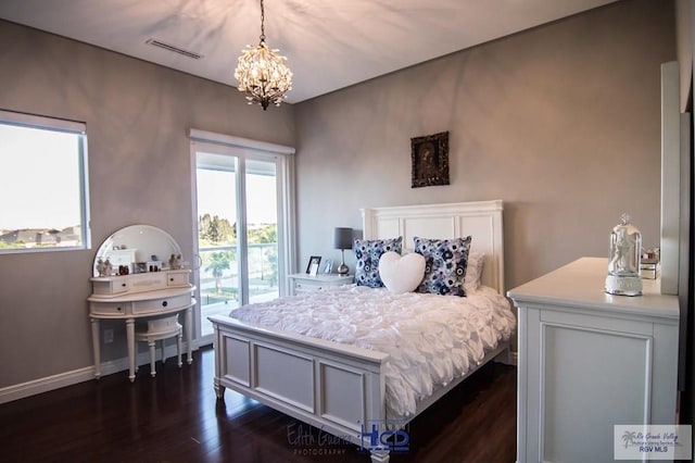 bedroom featuring a notable chandelier and dark hardwood / wood-style flooring