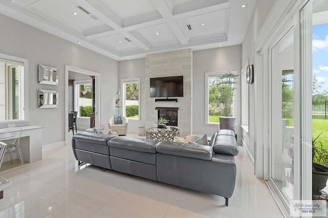 living room featuring beam ceiling, a wealth of natural light, a fireplace, and coffered ceiling