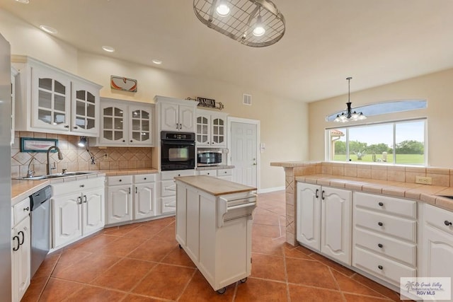 12612 E Clark Rd, La Feria, TX 78559 - kitchen with appliances with stainless steel finishes, a sink, decorative backsplash, white cabinets, and recessed lighting