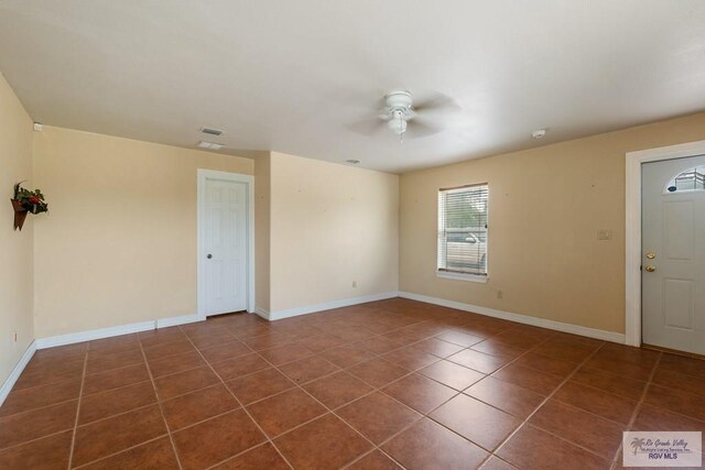 12612 E Clark Rd, La Feria, TX 78559 - unfurnished room with a ceiling fan, dark tile patterned floors, and baseboards