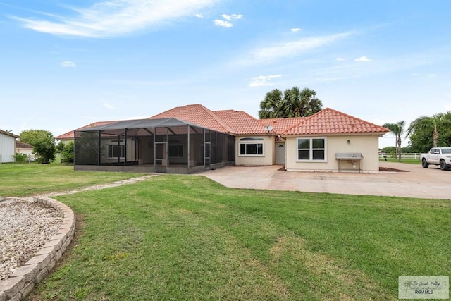 12612 E Clark Rd, La Feria, TX 78559 - back of house with a tile roof, a lawn, a patio area, and stucco siding