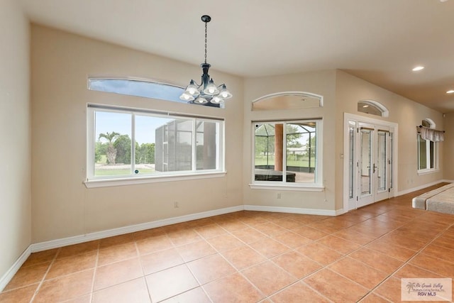 12612 E Clark Rd, La Feria, TX 78559 - empty room with light tile patterned flooring, a chandelier, recessed lighting, and baseboards