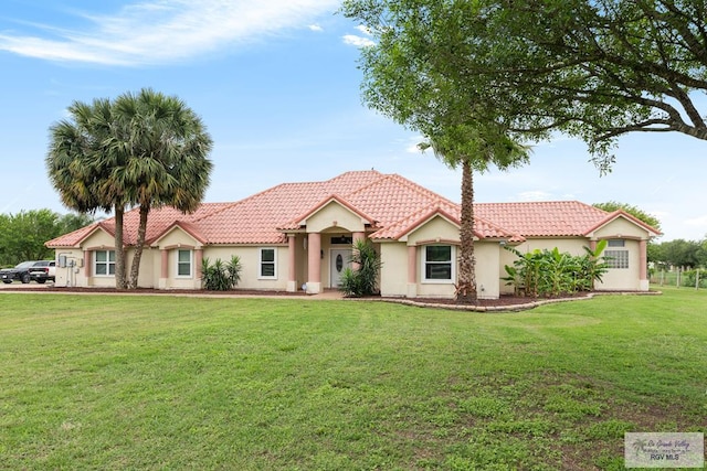12612 E Clark Rd, La Feria, TX 78559 - view of front of home with a front lawn, stucco siding, and a tiled roof