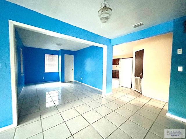 empty room featuring light tile patterned floors and a textured ceiling