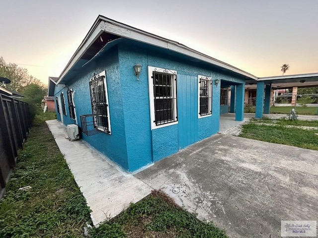 property exterior at dusk with a patio