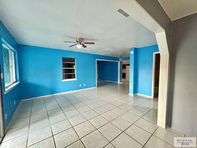 unfurnished living room with ceiling fan and light tile patterned floors