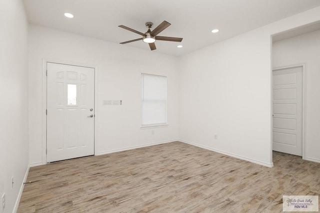 entrance foyer with ceiling fan and light hardwood / wood-style flooring