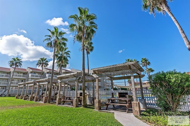 view of community with a pergola and a lawn